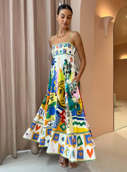 Vestido Midi Aquarela Dress Eleven com estampa vibrante em vista lateral, destacando alças finas e caimento leve.