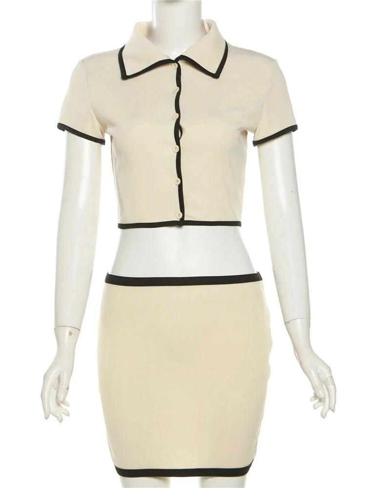 Vista frontal do conjunto feminino com gola estruturada e acabamento preto contrastante, em manequim