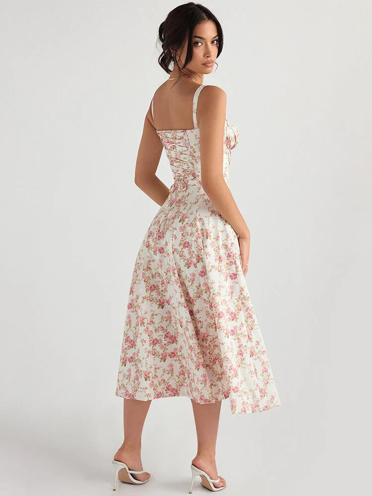 Vestido Amanda midi floral visto de costas, com alças finas e amarração ajustável que valoriza a silhueta.