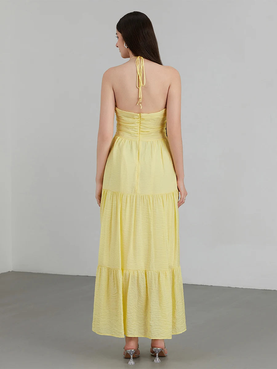 Vestido Diane amarelo em chiffon visto de costas, modelo longo com saia em camadas