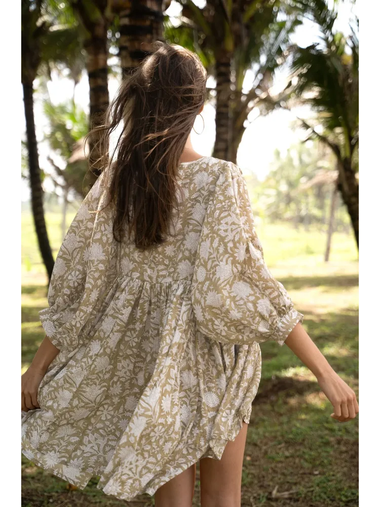Vista traseira do vestido Duna bege, modelagem ampla com caimento leve.
