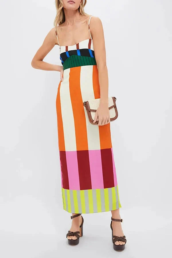 Mulher elegante com vestido longo colorido e bolsa de palha pequena nas mãos