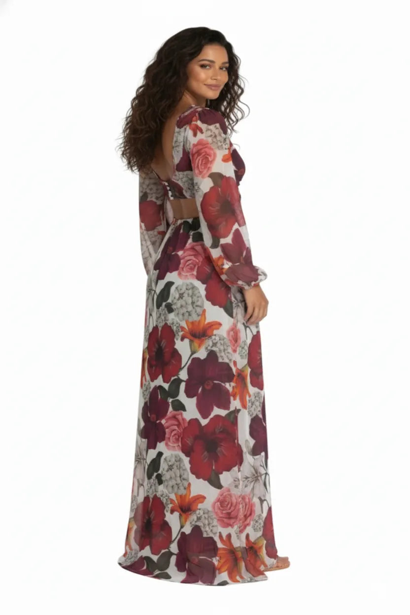 Vista traseira do Vestido Longo Tule Premium Jasmine Dress11 floral, com modelo olhando por cima do ombro, realçando a abertura nas costas e a fluidez do tecido.