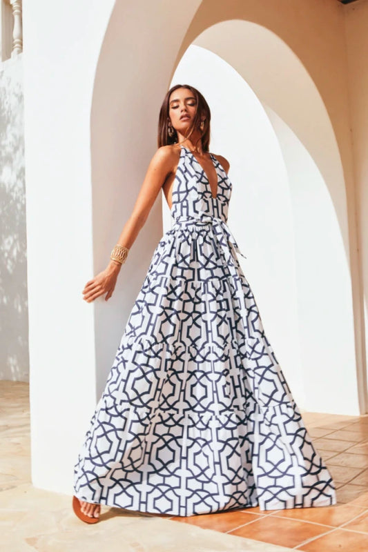 Vestido longo elegante estampado geométrico com decote halter profundo e amarração na cintura, look sofisticado para eventos.